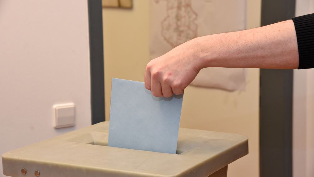 Hand mit Wahlzettel und Wahlurne. (Foto: Vorlaufer)