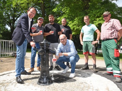 Sieben Personen posieren für ein Foto bei einem Trinkwasserbrunnen. (Foto: Josef Vorlaufer)
